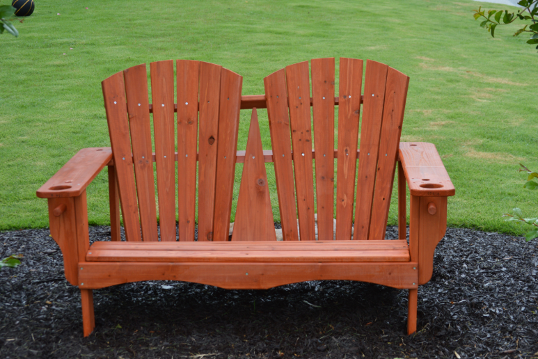 Red cedar Adirondack bench with cup holders, perfect for two.