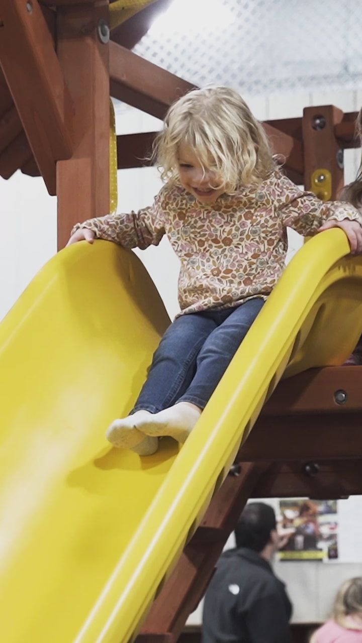 Child on a playset slide